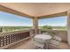 Relaxing outdoor balcony with scenic views, complete with a table and chairs at 6010 E Languid Ln, Carefree, AZ 85377