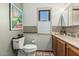 Well-lit bathroom with an art deco window, and toilet and vanity at 6010 E Languid Ln, Carefree, AZ 85377