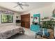 Bedroom features a ceiling fan, closet, a quaint window view, and comfortable furnishings at 6010 E Languid Ln, Carefree, AZ 85377