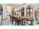 Bright dining room featuring arch windows, complemented by a wooden dining table and modern chairs at 6010 E Languid Ln, Carefree, AZ 85377