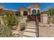 Inviting home entrance featuring well-maintained desert landscaping and a charming rustic gate at 6010 E Languid Ln, Carefree, AZ 85377