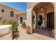 Charming front porch with arched entry and well-kept desert landscaping at 6010 E Languid Ln, Carefree, AZ 85377