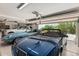 Spacious three-car garage featuring multiple luxury vehicles and an automatic door opener at 6010 E Languid Ln, Carefree, AZ 85377