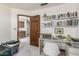 Home office with a bookshelf, built-ins, and a glass desk with plenty of room to work at 6010 E Languid Ln, Carefree, AZ 85377
