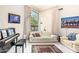 Cozy Living room featuring modern decor with seating area, piano, and large bright window at 6010 E Languid Ln, Carefree, AZ 85377