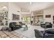 Open living room with stylish furnishings, a stone fireplace, and seamless indoor-outdoor living at 6010 E Languid Ln, Carefree, AZ 85377
