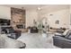 Spacious living room featuring a stone fireplace and comfortable black leather furniture at 6010 E Languid Ln, Carefree, AZ 85377