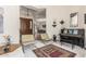 Inviting Living room featuring modern decor with seating area, piano, and tiled flooring at 6010 E Languid Ln, Carefree, AZ 85377