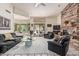 Spacious living room featuring a stone fireplace, comfortable seating, and access to outdoor living at 6010 E Languid Ln, Carefree, AZ 85377