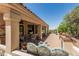 Comfortable outdoor seating on covered patio with views of the desert and built-in grill at 6010 E Languid Ln, Carefree, AZ 85377