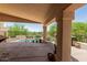 Covered patio overlooking pool with desert landscaping, perfect for relaxing and entertaining at 6010 E Languid Ln, Carefree, AZ 85377