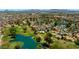 Expansive aerial view of a community with lush golf courses, sparkling lakes, and well-maintained homes at 631 Leisure World --, Mesa, AZ 85206
