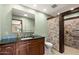 Bathroom with a modern vanity, large mirror, and a walk-in shower featuring decorative stone tiling at 631 Leisure World --, Mesa, AZ 85206