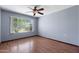 Bright bedroom with hardwood floors, a ceiling fan and a window letting in natural light at 631 Leisure World --, Mesa, AZ 85206