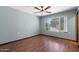 Cozy bedroom featuring hardwood floors, a ceiling fan and a window letting in natural light at 631 Leisure World --, Mesa, AZ 85206