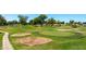 Scenic view of a well-maintained golf course featuring sand traps, manicured greens, and beautiful landscaping at 631 Leisure World --, Mesa, AZ 85206