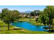 Beautiful golf course landscape with serene ponds, mature trees, and distant mountain views on a sunny day at 631 Leisure World --, Mesa, AZ 85206
