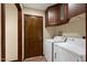 Functional laundry room featuring a washer, dryer, and overhead storage for added convenience at 631 Leisure World --, Mesa, AZ 85206
