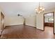 Spacious living room with wood-look floors and a decorative chandelier fixture overhead at 631 Leisure World --, Mesa, AZ 85206