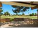 Covered patio area overlooking a lush green golf course with mature trees at 631 Leisure World --, Mesa, AZ 85206