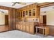 Unique wet bar with wood cabinetry and glass door display cabinets at 631 Leisure World --, Mesa, AZ 85206