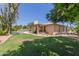Spacious backyard showing a covered patio, pool, and lush lawn, ideal for entertaining and relaxation at 6417 E Kings Ave, Scottsdale, AZ 85254
