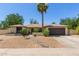 Charming single-story home featuring desert landscaping, a brick facade, and a two-car garage at 6417 E Kings Ave, Scottsdale, AZ 85254