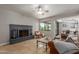 Relaxing living room showcases a brick fireplace, travertine flooring, ceiling fan and outside views at 6417 E Kings Ave, Scottsdale, AZ 85254
