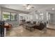 Open living room exhibits travertine flooring, views to the kitchen, and a comfortable seating arrangement at 6417 E Kings Ave, Scottsdale, AZ 85254