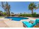 Backyard pool with patio furniture and native desert vegetation surrounding the area at 6417 E Kings Ave, Scottsdale, AZ 85254