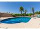 Outdoor pool with clear blue water, surrounded by concrete and lush green landscaping at 6417 E Kings Ave, Scottsdale, AZ 85254