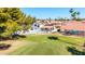 Aerial view of a property with a swimming pool, a tiled roof, and a spacious lawn at 7108 W Morrow Dr, Glendale, AZ 85308