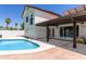 The home's backyard pool area and covered patio with a wooden pergola create a relaxing outdoor living space at 7108 W Morrow Dr, Glendale, AZ 85308