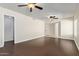 Bedroom featuring wood floors, ceiling fans, and natural light from a large window at 7108 W Morrow Dr, Glendale, AZ 85308
