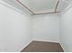 Walk-in closet with brown flooring and metal rods for storage at 7108 W Morrow Dr, Glendale, AZ 85308
