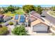 Aerial view of this beautiful home with solar panels, a red tile roof, and desert landscaping at 7108 W Morrow Dr, Glendale, AZ 85308
