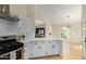 Kitchen featuring white cabinets, breakfast bar area, and stainless steel stove at 7108 W Morrow Dr, Glendale, AZ 85308