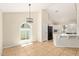 Eat-in kitchen featuring white cabinets, sleek black appliances, and bright natural lighting at 7108 W Morrow Dr, Glendale, AZ 85308