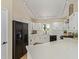 Bright kitchen featuring white cabinets, black appliances, and light countertops with a breakfast bar at 7108 W Morrow Dr, Glendale, AZ 85308