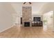 Spacious living room with vaulted ceilings, stone fireplace, tile floors, and a ceiling fan at 7108 W Morrow Dr, Glendale, AZ 85308