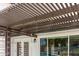 Covered patio featuring a wooden pergola with decorative lights, view of backyard with a pool, and white exterior siding at 7108 W Morrow Dr, Glendale, AZ 85308