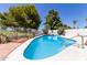 Backyard pool features a white concrete deck, desert landscaping, and a safety fence at 7108 W Morrow Dr, Glendale, AZ 85308