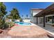 Inviting backyard pool area features desert landscaping, a large patio, and a covered outdoor living space at 7108 W Morrow Dr, Glendale, AZ 85308