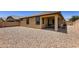 Exterior view of house with backyard featuring desert landscaping at 7665 W Fetlock Trl, Peoria, AZ 85383