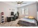 Comfortable bedroom with plush carpet, natural light, and a ceiling fan at 7665 W Fetlock Trl, Peoria, AZ 85383