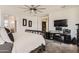 Well-lit bedroom features large windows, a ceiling fan, and a dedicated workspace at 7665 W Fetlock Trl, Peoria, AZ 85383