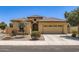 Charming single-story home featuring a tile roof, desert landscaping, and a two-car garage at 7665 W Fetlock Trl, Peoria, AZ 85383