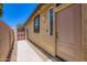 Exterior view of property featuring side yard with gate, stucco, rocks, and front door at 7665 W Fetlock Trl, Peoria, AZ 85383