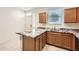 Modern kitchen featuring granite countertops and bright cabinetry at 7665 W Fetlock Trl, Peoria, AZ 85383