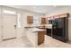 Bright kitchen with stainless steel appliances, granite countertops, and tile flooring at 7665 W Fetlock Trl, Peoria, AZ 85383